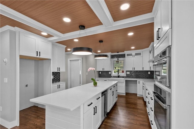 201 Bellman Ave, Warwick, RI 02889 - kitchen with a kitchen island, dark wood-style floors, backsplash, recessed lighting, and white cabinets
