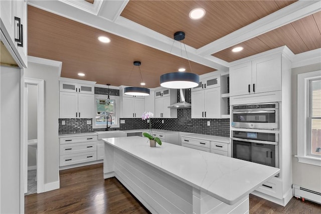 201 Bellman Ave, Warwick, RI 02889 - kitchen featuring baseboard heating, wall chimney exhaust hood, decorative backsplash, white cabinets, and glass insert cabinets