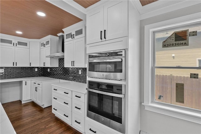 201 Bellman Ave, Warwick, RI 02889 - kitchen featuring wall chimney range hood, double oven, glass insert cabinets, recessed lighting, and backsplash
