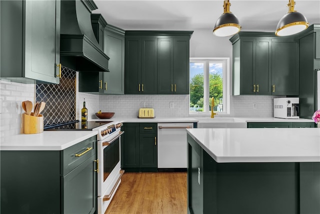 93 E Main Rd, Portsmouth, RI 02871 - kitchen featuring white appliances, green cabinetry, premium range hood, light countertops, and tasteful backsplash