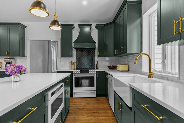 93 E Main Rd, Portsmouth, RI 02871 - kitchen featuring green cabinets, electric range, built in microwave, and premium range hood