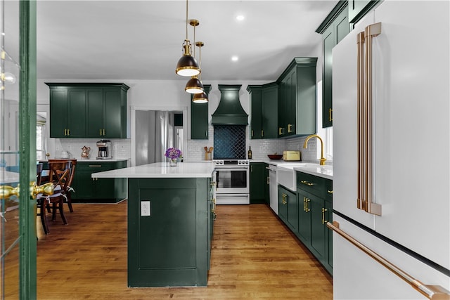 93 E Main Rd, Portsmouth, RI 02871 - kitchen featuring appliances with stainless steel finishes, green cabinetry, custom exhaust hood, and recessed lighting