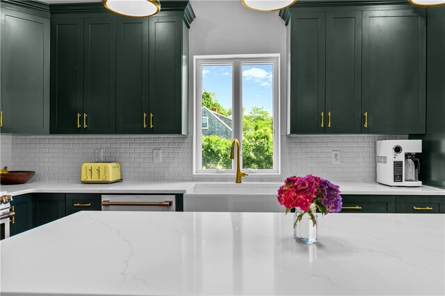 93 E Main Rd, Portsmouth, RI 02871 - kitchen featuring green cabinetry, decorative backsplash, and light stone countertops