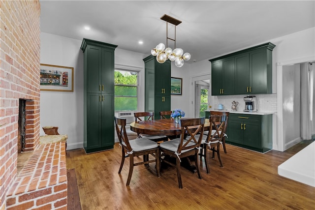 93 E Main Rd, Portsmouth, RI 02871 - dining area featuring healthy amount of natural light, a brick fireplace, wood finished floors, recessed lighting, and a chandelier