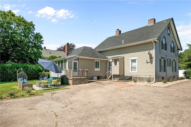 93 E Main Rd, Portsmouth, RI 02871 - back of house featuring a chimney, an outdoor living space, roof with shingles, and a patio
