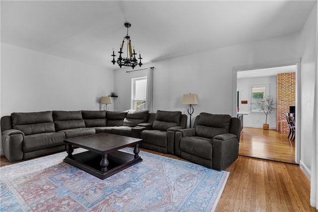 93 E Main Rd, Portsmouth, RI 02871 - living room with light wood-style flooring, a chandelier, and a fireplace