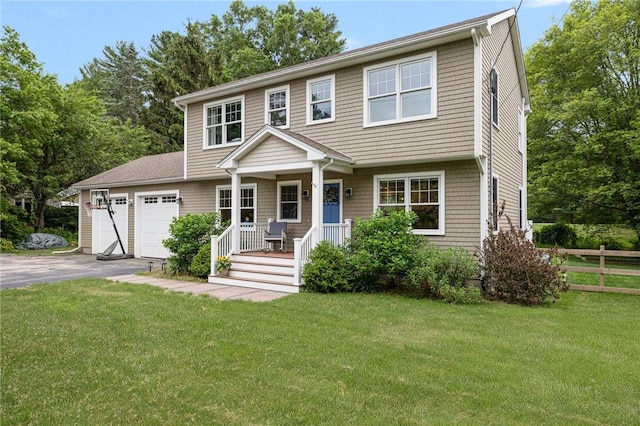 43 Shannock Hill Rd, Richmond, RI 02812 - colonial house featuring asphalt driveway, covered porch, and an attached garage