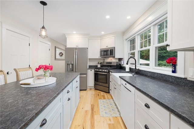 43 Shannock Hill Rd, Richmond, RI 02812 - kitchen featuring appliances with stainless steel finishes, white cabinets, light wood finished floors, decorative light fixtures, and recessed lighting