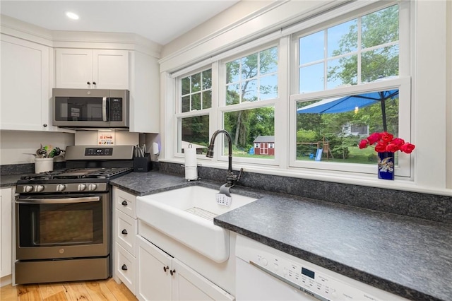 43 Shannock Hill Rd, Richmond, RI 02812 - kitchen with stainless steel appliances, dark countertops, white cabinetry, and light wood-type flooring