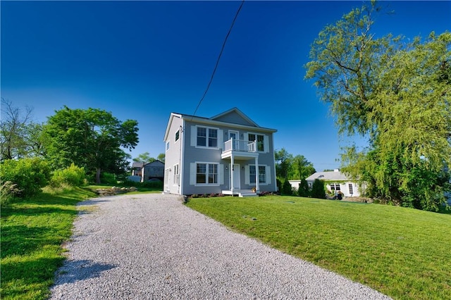 24 Seaspray Way, Little Compton, RI 02837 - view of front of home with a balcony, gravel driveway, and a front lawn