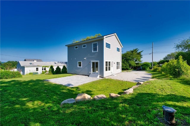 24 Seaspray Way, Little Compton, RI 02837 - back of property with a patio area, a lawn, and entry steps