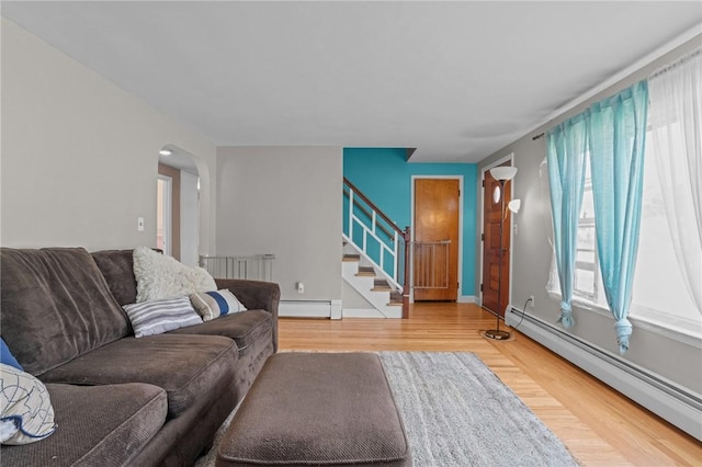 56 Brookfield Dr, Cranston, RI 02920 - living room featuring baseboard heating, wood finished floors, stairs, and arched walkways