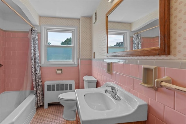 56 Brookfield Dr, Cranston, RI 02920 - full bath with radiator heating unit, healthy amount of natural light, wallpapered walls, shower / tub combo, and a wainscoted wall