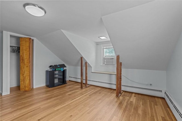 56 Brookfield Dr, Cranston, RI 02920 - additional living space with cooling unit, wood finished floors, a baseboard heating unit, and vaulted ceiling