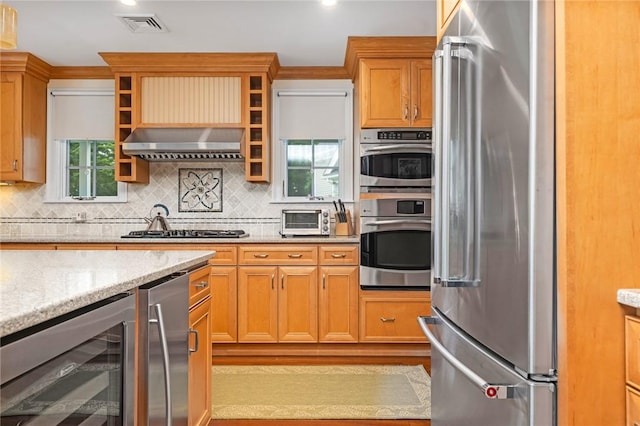 583 Highland Rd, Tiverton, RI 02878 - kitchen featuring appliances with stainless steel finishes, beverage cooler, extractor fan, decorative backsplash, and plenty of natural light