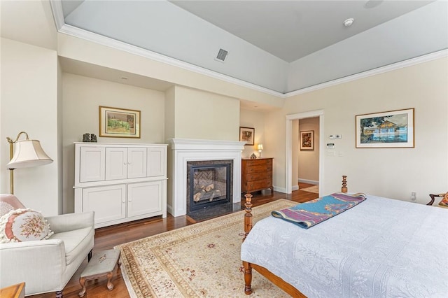583 Highland Rd, Tiverton, RI 02878 - bedroom featuring wood finished floors, a tray ceiling, a fireplace with flush hearth, and crown molding