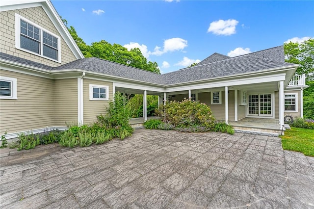 583 Highland Rd, Tiverton, RI 02878 - back of property with a shingled roof and covered porch