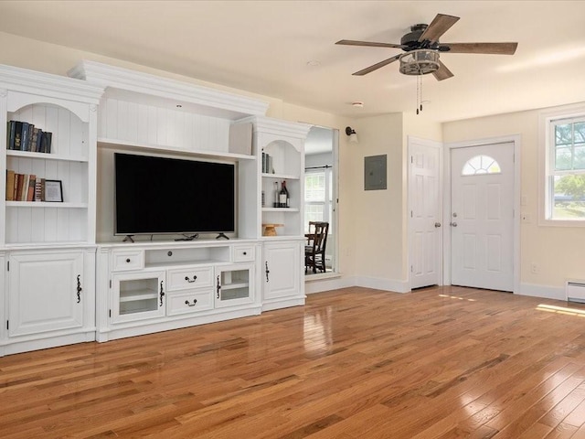 96 Ashaway Rd, Westerly, RI 02891 - unfurnished living room with electric panel, light wood finished floors, ceiling fan, and a baseboard heating unit