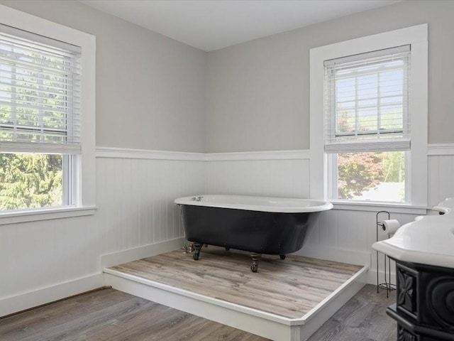 96 Ashaway Rd, Westerly, RI 02891 - full bath with wainscoting, a freestanding bath, healthy amount of natural light, and wood finished floors