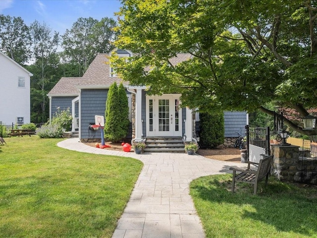 96 Ashaway Rd, Westerly, RI 02891 - view of front facade with french doors, a front lawn, and a shingled roof