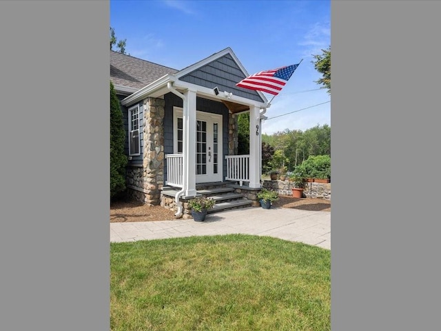 96 Ashaway Rd, Westerly, RI 02891 - view of front facade with stone siding, french doors, and a front yard