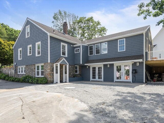 96 Ashaway Rd, Westerly, RI 02891 - shingle-style home featuring french doors, a chimney, and stone siding