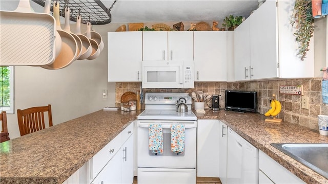 36 Primrose Ln Unit 36, North Providence, RI 02904 - kitchen featuring white appliances, a peninsula, backsplash, white cabinetry, and dark countertops