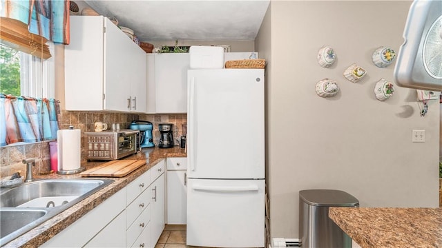 36 Primrose Ln Unit 36, North Providence, RI 02904 - kitchen with freestanding refrigerator, tasteful backsplash, white cabinets, and light tile patterned flooring