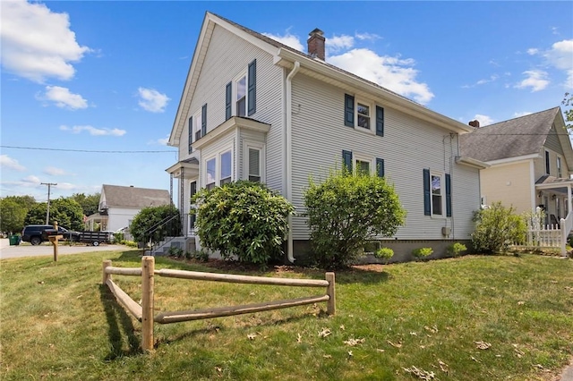358 Pawtuxet Ave, Warwick, RI 02888 - view of property exterior featuring a chimney and a yard