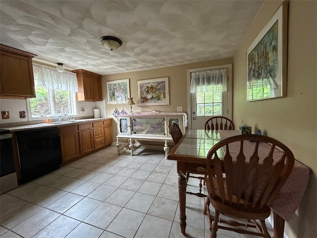 163 Reynolds Ave, Warwick, RI 02889 - kitchen featuring dishwasher, plenty of natural light, light tile patterned flooring, tile counters, and a textured ceiling