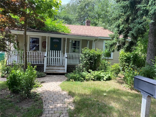 163 Reynolds Ave, Warwick, RI 02889 - ranch-style home with a chimney and covered porch