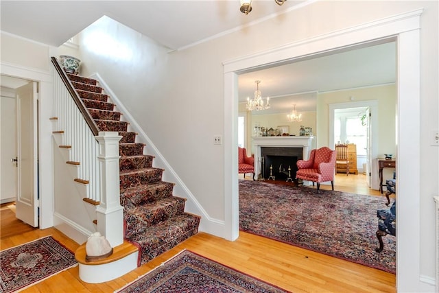 65 Lyndhurst Ave, Providence, RI 02908 - stairway with wood finished floors and a chandelier