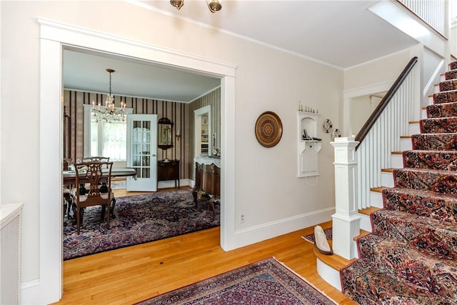 65 Lyndhurst Ave, Providence, RI 02908 - stairway with wood finished floors, crown molding, and a chandelier