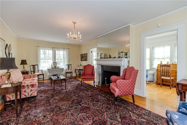 65 Lyndhurst Ave, Providence, RI 02908 - living room featuring crown molding, wood finished floors, a chandelier, and a fireplace