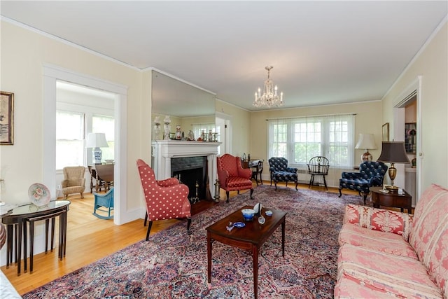 65 Lyndhurst Ave, Providence, RI 02908 - living area featuring crown molding, wood finished floors, a chandelier, and a fireplace