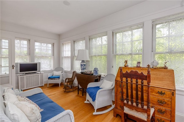65 Lyndhurst Ave, Providence, RI 02908 - sunroom / solarium with wood finished floors, plenty of natural light, and radiator heating unit