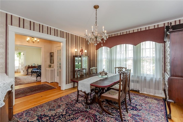 65 Lyndhurst Ave, Providence, RI 02908 - dining area with a chandelier, wallpapered walls, and light wood-type flooring