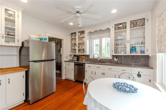65 Lyndhurst Ave, Providence, RI 02908 - kitchen featuring appliances with stainless steel finishes, wood finished floors, ornamental molding, tasteful backsplash, and a ceiling fan