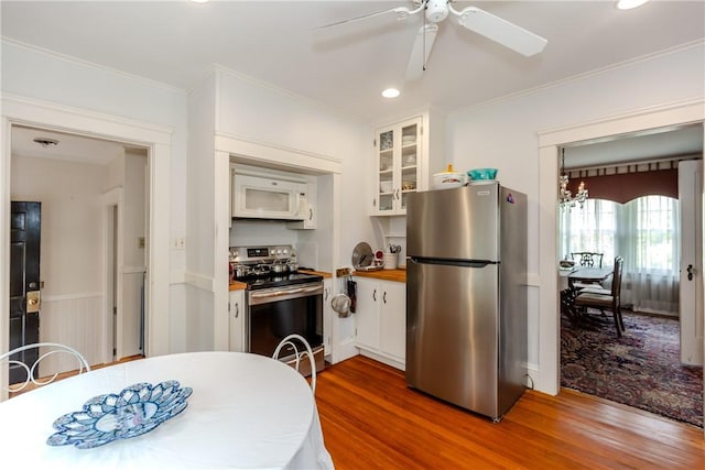 65 Lyndhurst Ave, Providence, RI 02908 - kitchen featuring appliances with stainless steel finishes, wood finished floors, white cabinetry, crown molding, and ceiling fan