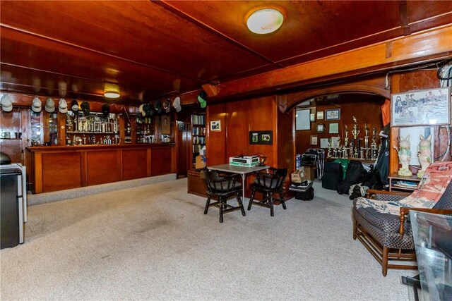 65 Lyndhurst Ave, Providence, RI 02908 - carpeted dining space with a bar and wood walls