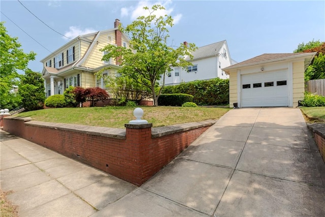 65 Lyndhurst Ave, Providence, RI 02908 - view of front of house with a front yard, concrete driveway, a chimney, a gambrel roof, and a detached garage