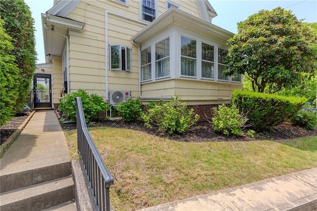 65 Lyndhurst Ave, Providence, RI 02908 - view of property exterior featuring a cooling unit and a lawn