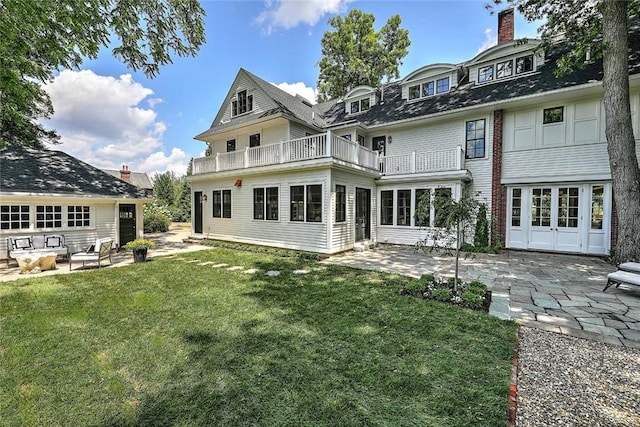 290 Blackstone Blvd, Providence, RI 02906 - back of house with a balcony, a patio area, a lawn, and a chimney
