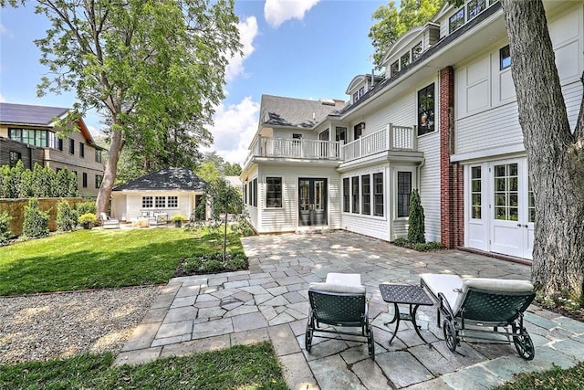 290 Blackstone Blvd, Providence, RI 02906 - rear view of house with a lawn, a patio, a balcony, french doors, and an outbuilding