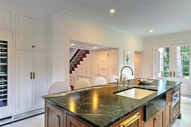 290 Blackstone Blvd, Providence, RI 02906 - kitchen featuring a center island with sink, dark stone counters, crown molding, recessed lighting, and french doors