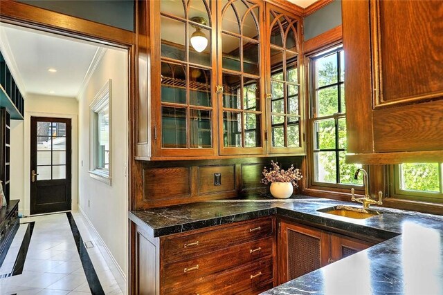 290 Blackstone Blvd, Providence, RI 02906 - kitchen with inlaid floor details, crown molding, glass insert cabinets, and tile patterned flooring