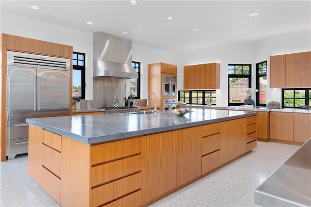 82 Nonquit Ln, Tiverton, RI 02878 - kitchen with appliances with stainless steel finishes, modern cabinets, recessed lighting, dark speckled floor, and wall chimney exhaust hood