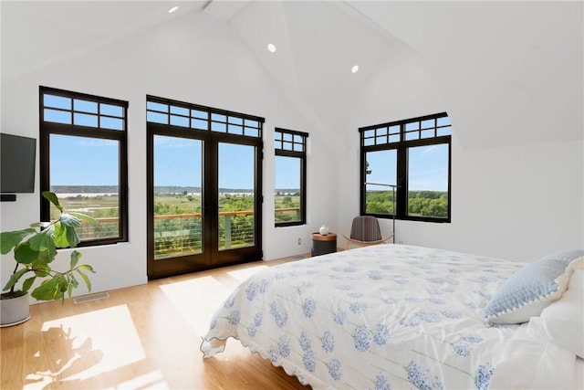 82 Nonquit Ln, Tiverton, RI 02878 - bedroom with high vaulted ceiling, recessed lighting, access to exterior, and wood finished floors