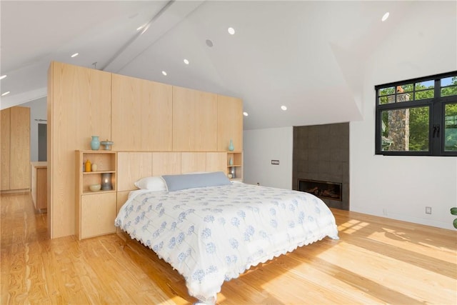 82 Nonquit Ln, Tiverton, RI 02878 - bedroom featuring light wood-type flooring, a tile fireplace, recessed lighting, and high vaulted ceiling