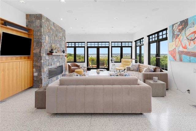 82 Nonquit Ln, Tiverton, RI 02878 - living area featuring dark aggregate flooring, plenty of natural light, a fireplace, and recessed lighting